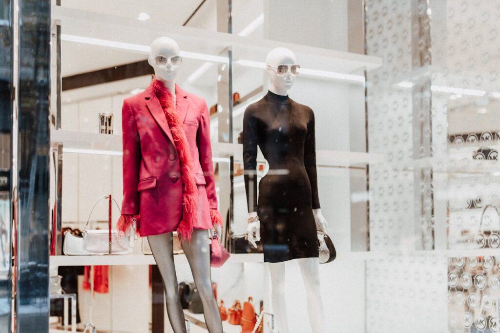 Stylish mannequins in a fashion store window showcasing modern attire. Perfect for shopping inspiration.
