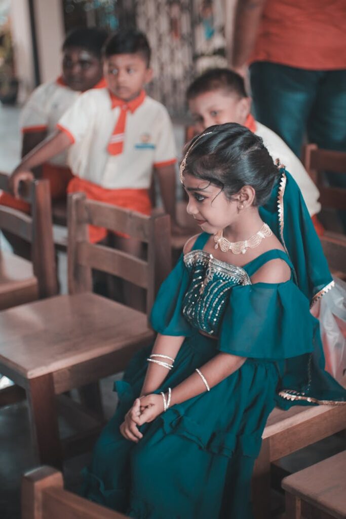 Young children in traditional clothing attending a school event in Malaysia.